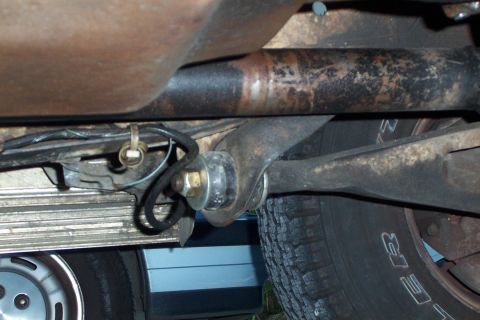 1980 Ford Bronco - A close-up shot reveals the underside of a vehicle, focusing on its mechanical components and tire tread.