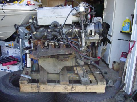 1987 Ford Bronco - Engine assembly displayed on a wooden pallet, ready for installation or repair.