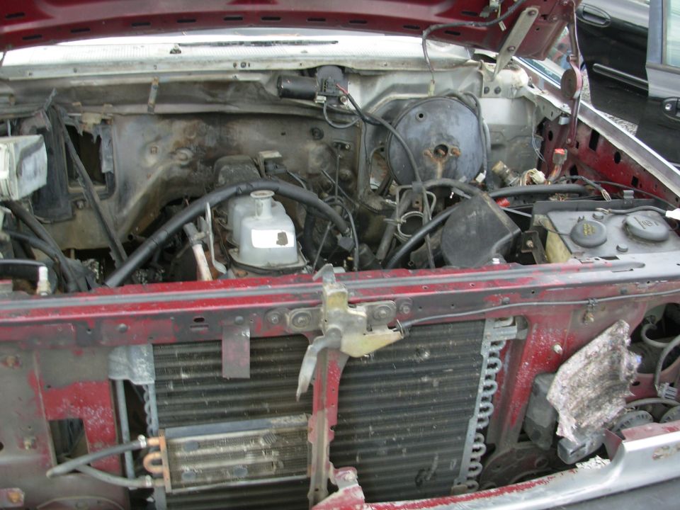 Engine bay of a stripped truck with radiator and reservoir
