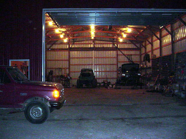 Maroon 1992 Ford Bronco parked in a garage with the door open