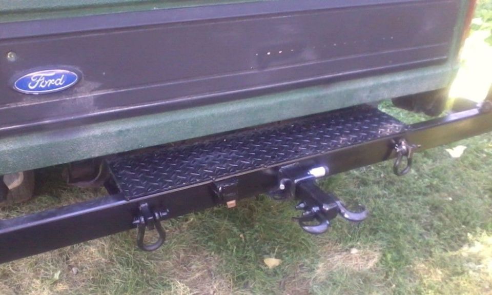 Closeup.  Some diamond tread for standing on.  D-rings for recovery points, electrical hookup for a trailer and a 2" receiver, currently holding a custom recovery hitch I fabbed up years earlier.
