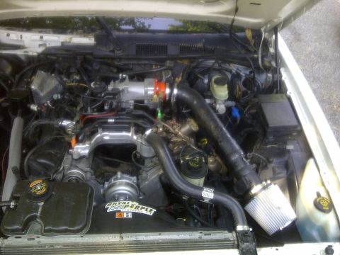 2000 Ford Crown Victoria - Engine bay shows aftermarket parts including a custom intake and intercooler piping.