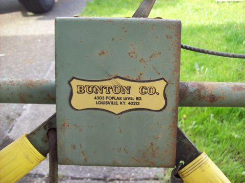 1995 Ford Bronco - A close-up of a Bunton Co. sign on a weathered green metal gate.