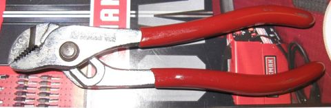 2000 Ford Crown Victoria - A pair of pliers with red handles sits on top of a red Craftsman toolbox.