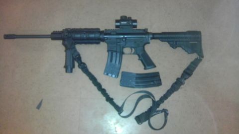 2000 Mercury Grand Marquis - An AR-15 style rifle is displayed with a bipod, red dot sight, and two magazines, suggesting it is a part or accessory.