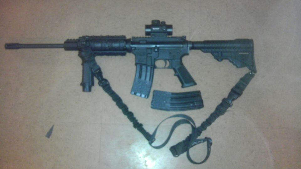 AR-15 style rifle with bipod, red dot sight, and two magazines