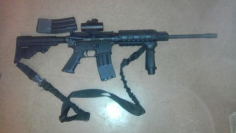 2000 Mercury Grand Marquis - AR-15 style rifle with accessories laid out on a floor.