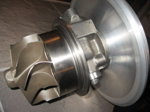 1965 Ford Fairlane - Close-up view of a turbocharger turbine wheel and housing, with 'SUPERMOTORS.net' visible at the bottom right.
