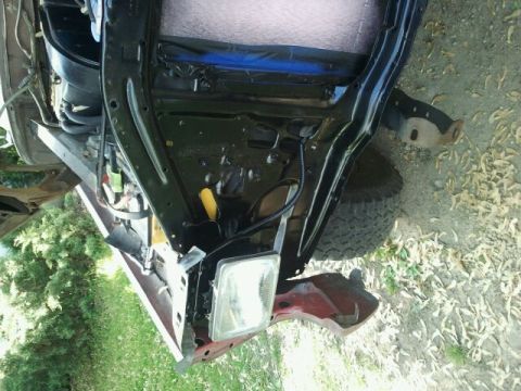 1979 Ford Bronco - The front section of a vehicle, possibly undergoing repairs or restoration, is shown from a low angle.