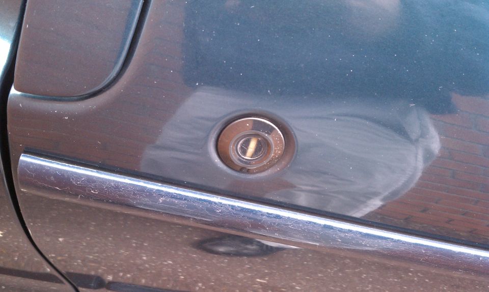 Door lock cylinder on dark blue car