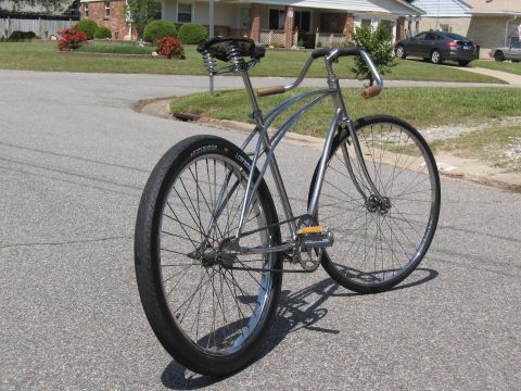 1994 Ford Bronco - A custom cruiser bicycle with a chrome frame and wide tires is parked on a suburban street.