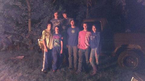 1979 Ford Bronco - A group of people stand in front of a brown 1978 Ford Bronco at night.
