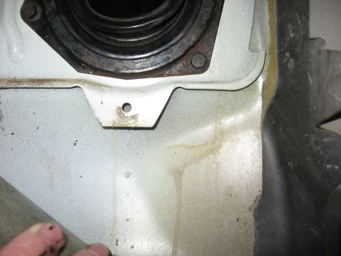 1994 Ford Bronco - Detail of a vehicle's interior shows a rubber boot and surrounding metal components.