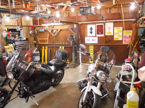 1993 Ford Bronco - A workshop scene with two motorcycles parked inside, surrounded by various tools and garage equipment.