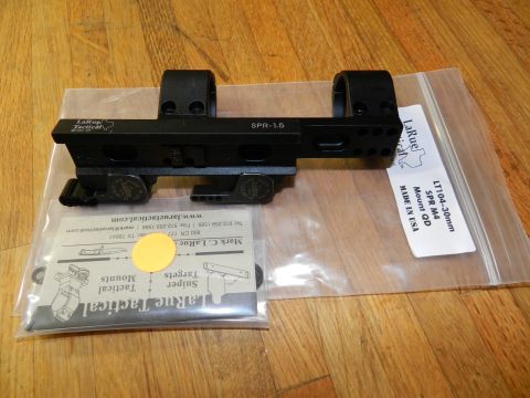1996 Ford Bronco - LaRue Tactical SPR-1.5 scope mount and its packaging are shown on a wooden surface.