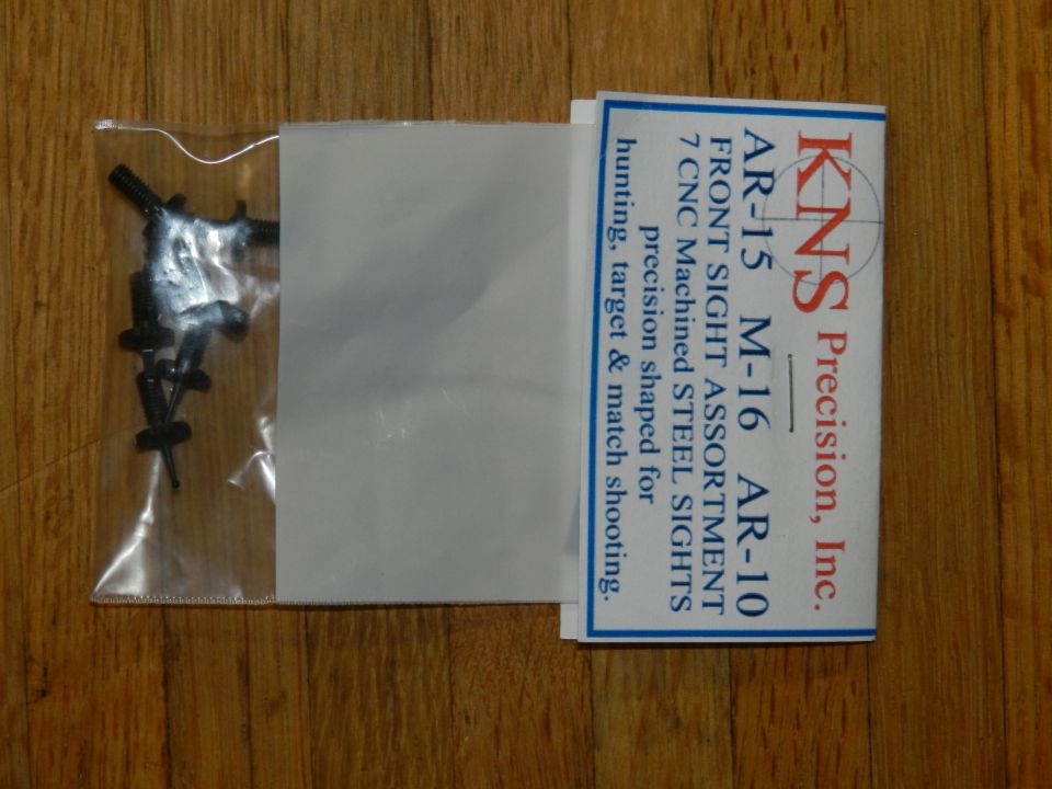 Bag of black front sights for AR-15, M-16, and AR-10 rifles. Package includes text from KNS Precision