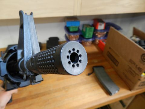 1996 Ford Bronco - A close-up view of a gun muzzle brake, showing its perforated design and multiple ports.