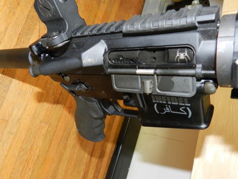 1996 Ford Bronco - This AR-15 style rifle features custom engravings, including a spider emblem and the word 'Infidel'.