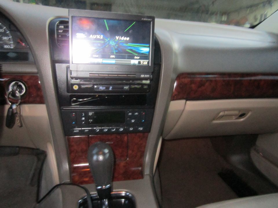 Car interior with aftermarket screen displaying "AUX2 Video" and GPS