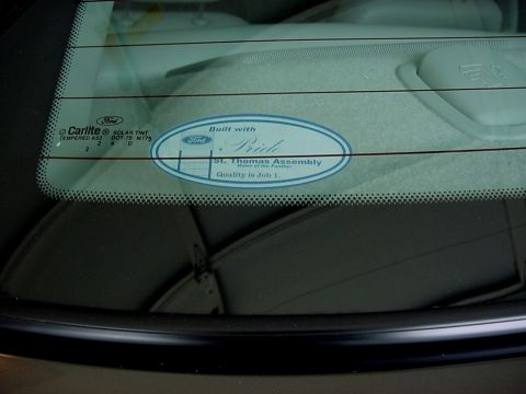2003 Mercury Grand Marquis - A sticker on the rear window of a car reads 'Built with Pride' and 'St. Thomas Assembly'.