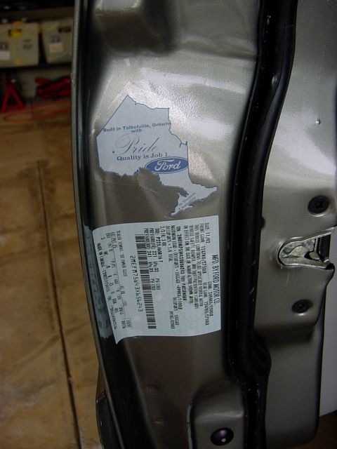 2003 Mercury Grand Marquis - A door jamb sticker shows a Ford logo and a map of Ontario, indicating the vehicle was built in Talbotville, Ontario.