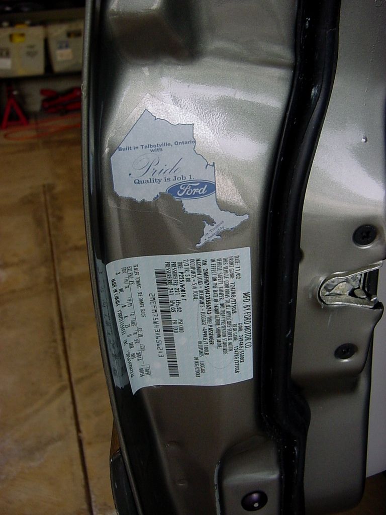 Door-jamb Talbotville, Ontario "Quality is Job 1" decal above the Ford certification and tire label