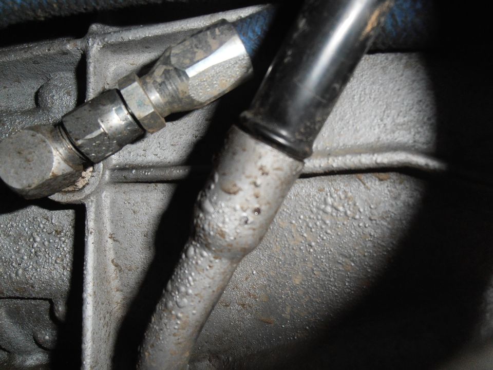 Transmission dipstick tube pressed into aluminum case beside cooler line