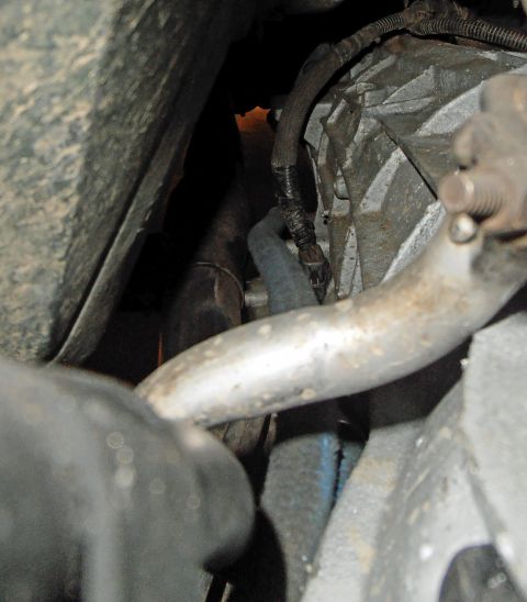 1990 Ford Bronco - Underside view of vehicle mechanical components, including transmission and exhaust.