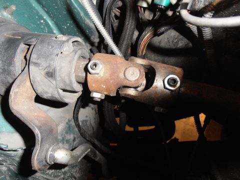 1990 Ford Bronco - Close-up view of a vehicle's steering shaft universal joint, showing rust and hardware.