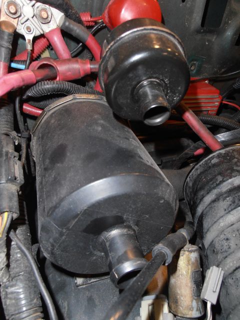 1990 Ford Bronco - Engine bay components including canisters and wiring are visible in this close-up shot.