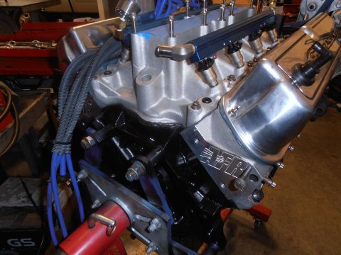 1990 Ford Bronco - Close-up of an engine block a chrome valve cover and fuel injection system.