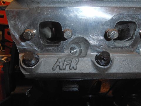 1990 Ford Bronco - Close-up of an aftermarket aluminum engine cylinder head with the AFR logo visible.