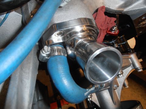 1990 Ford Bronco - Engine component with blue hose and clamp, likely part of a cooling system.