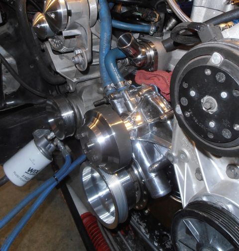 1990 Ford Bronco - Close-up view of engine components including pulleys, hoses, and a Wix fluid filter.