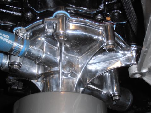 1990 Ford Bronco - Close-up of a polished chrome water pump, part of an engine assembly.