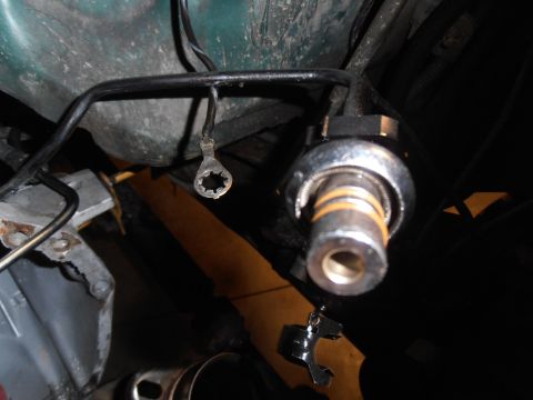 1990 Ford Bronco - Close-up view of a fuel injector, likely from a vehicle's fuel system.