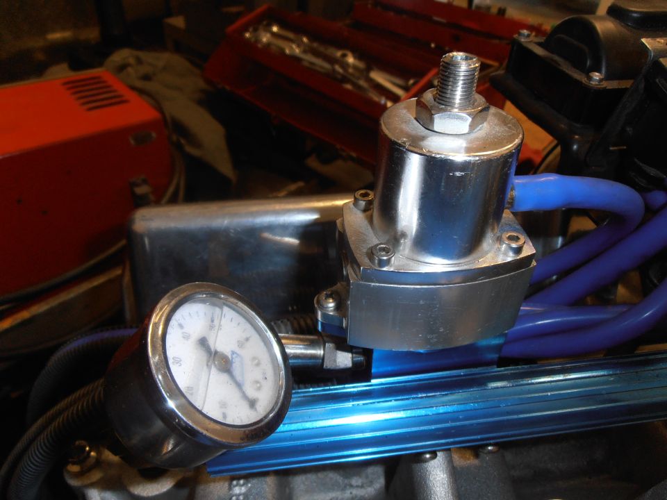 Close-up of a chrome fuel pressure regulator with a gauge showing pressure