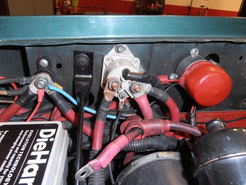 1990 Ford Bronco - Close-up view of the engine bay wiring, including battery terminals and cables, with a DieHard battery visible.