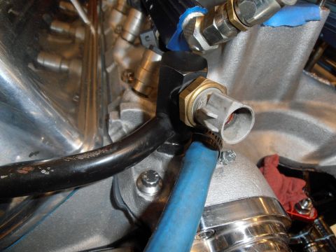 1990 Ford Bronco - Engine component detail showing a sensor connected to a hose and various metal parts.