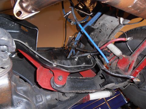 1990 Ford Bronco - Close-up view of the underbody suspension and exhaust system of a vehicle.
