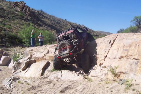 1981 Ford F-150 - This heavily modified off-road vehicle navigates a challenging rocky terrain.