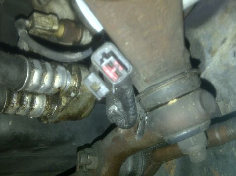 2000 Ford Crown Victoria - Automotive part with an electrical connector and metal tubing visible.