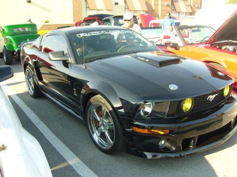 2007 Ford Mustang - A black Ford Mustang is parked at an outdoor event with other vehicles visible.