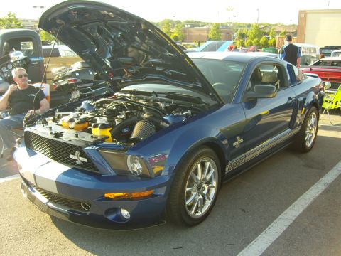 2007 Ford Mustang - A blue Ford Mustang GT500 is parked with its hood open, revealing the engine bay.