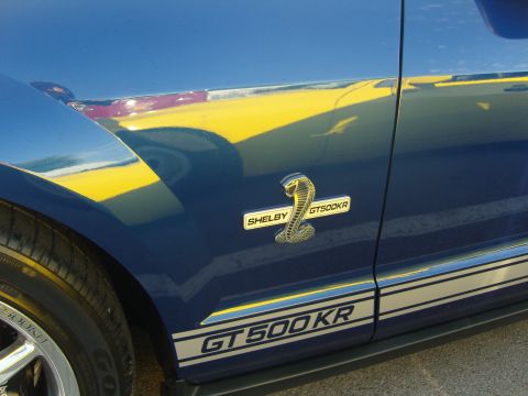 2007 Ford Mustang - A blue 2007 Ford Mustang GT500KR side view shows the Shelby badge and GT500KR stripe.