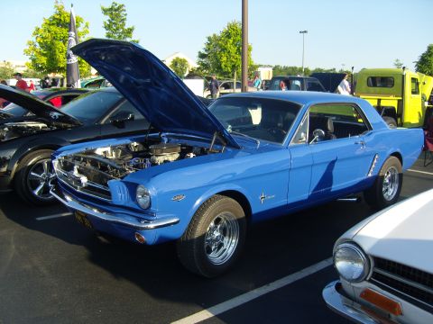 2007 Ford Mustang - A classic blue Ford Mustang is displayed with its hood open at a car event.