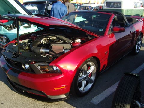2007 Ford Mustang - Red 2007 Ford Mustang convertible at a car show, hood open to display the engine.
