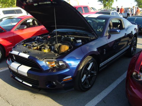 2007 Ford Mustang - A blue Ford Mustang GT500 is displayed with its hood open, revealing the engine compartment.