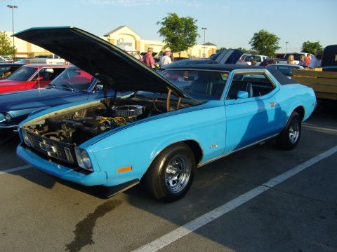 2007 Ford Mustang - Classic blue coupe at a car show, hood raised to reveal the engine bay.