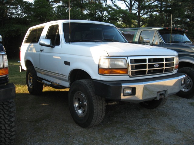 White Ford Bronco with chrome accents and a winch on the front bumper
